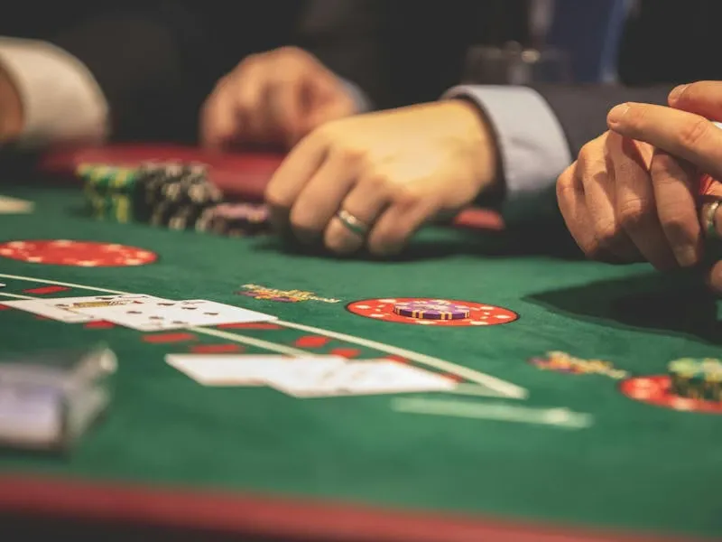 Sophisticated gaming lounge showcasing a lady in crimson dress beside the roulette wheel — CrownBD’s signature luxurious feel.